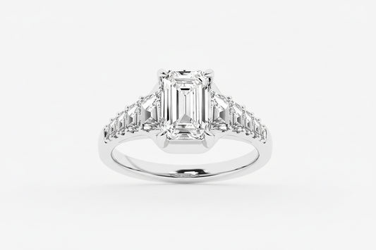 Diamond ring with emerald-cut center stone and baguette side stones on a white background