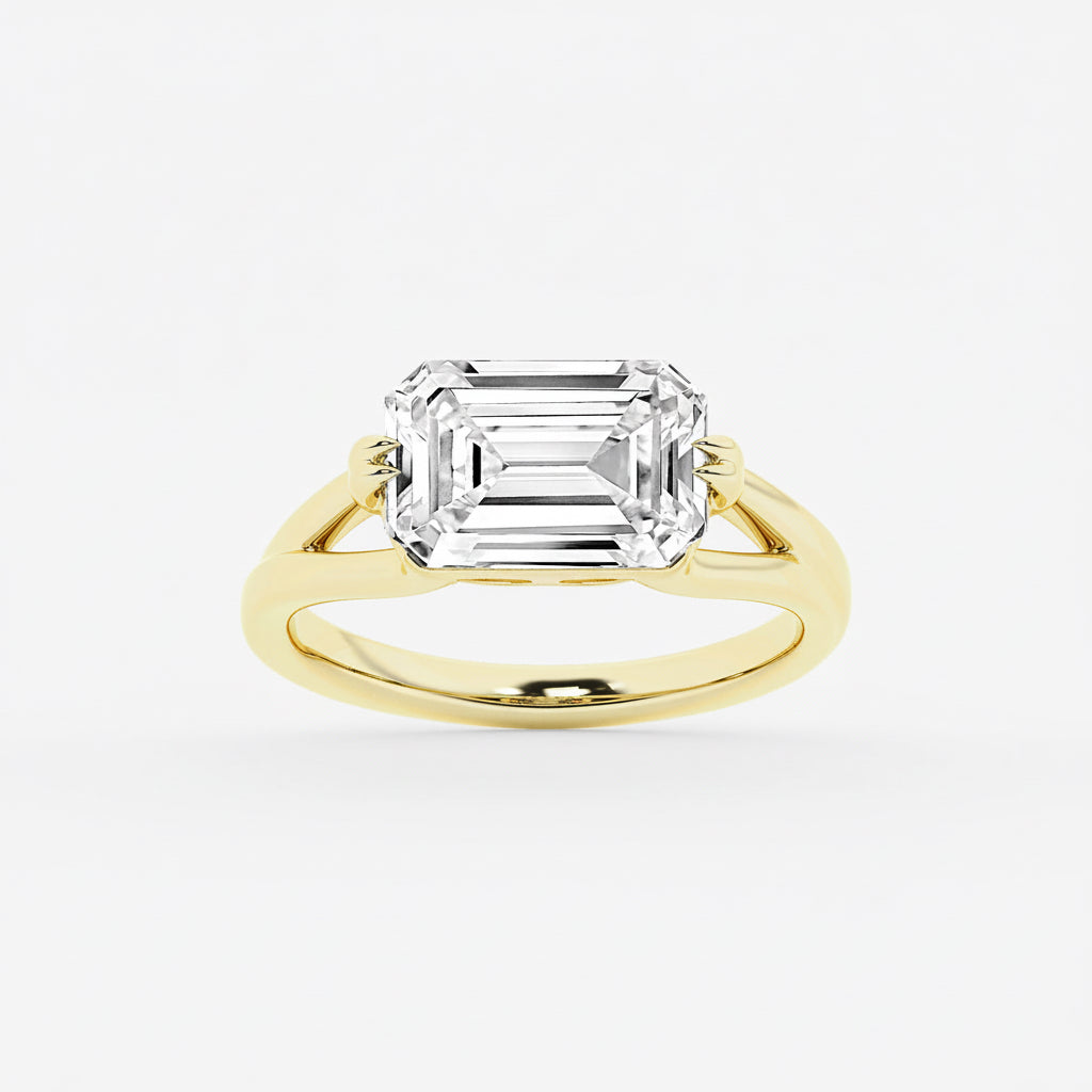 Gold ring with a large emerald-cut diamond on a white background
