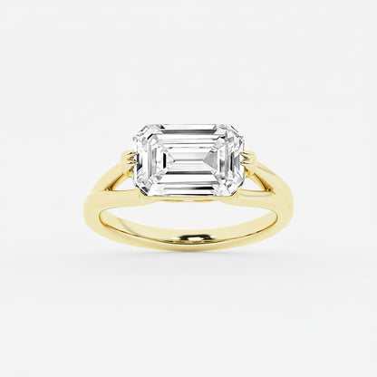 Gold ring with a large emerald-cut diamond on a white background