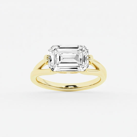Gold ring with a large emerald-cut diamond on a white background