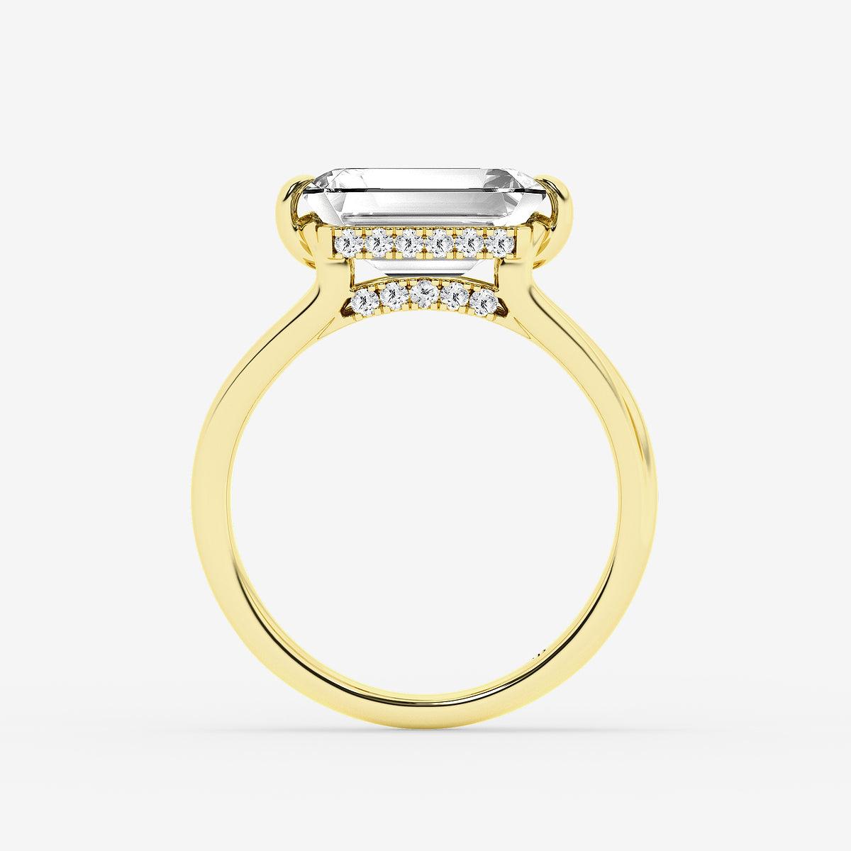 Gold ring with a large emerald-cut center stone and smaller diamonds on a white background