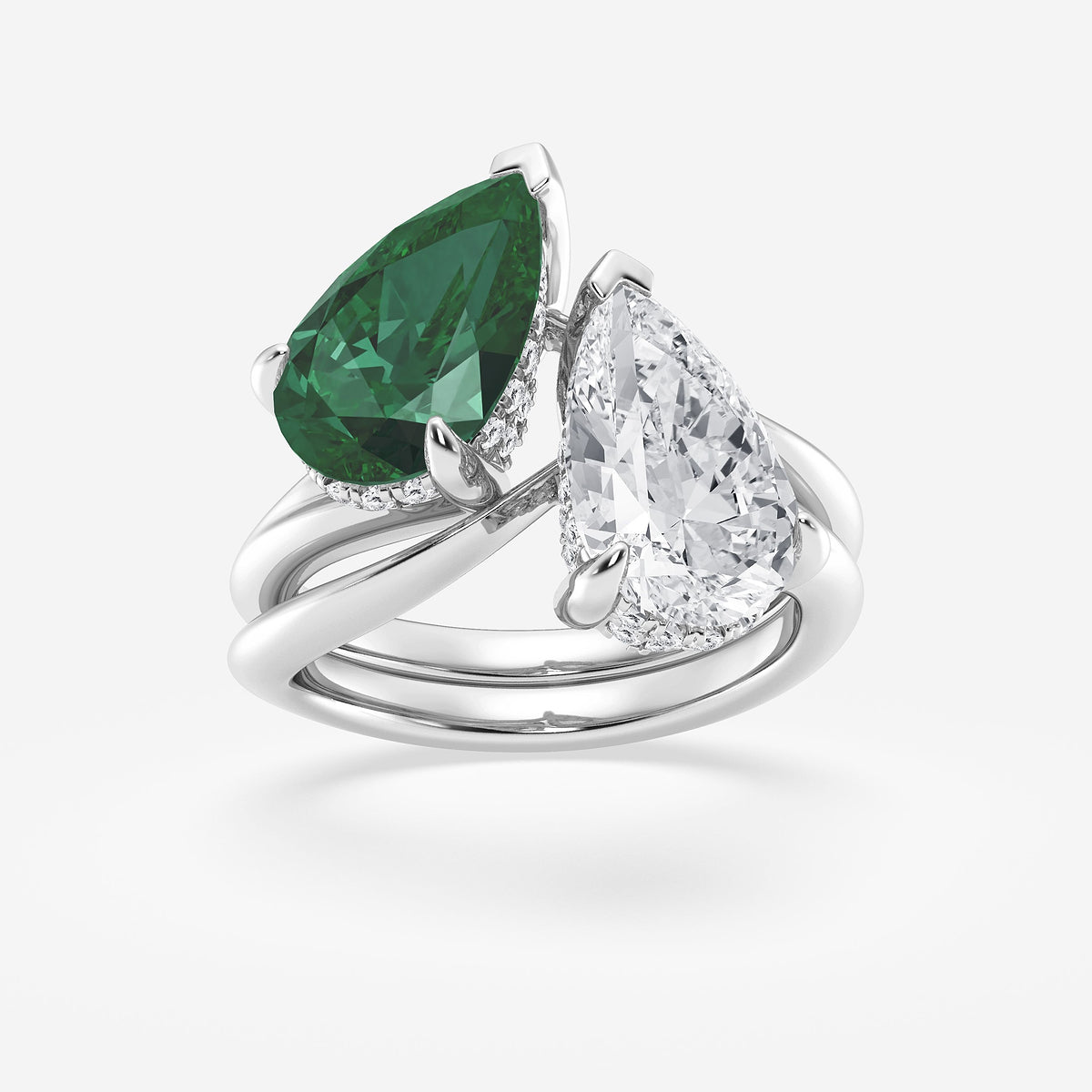 Ring with green gemstone and clear diamond on a white background
