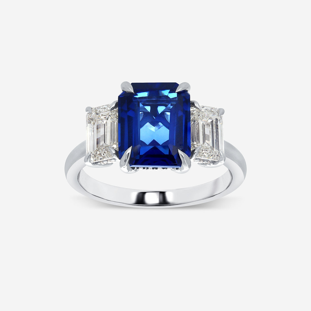Ring with a blue gemstone and diamond-like stones on a white background