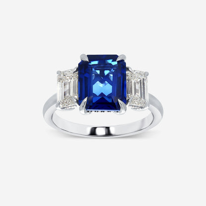 Ring with a blue gemstone and diamond-like stones on a white background