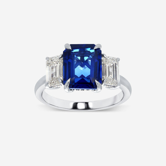Ring with a blue gemstone and diamond-like stones on a white background