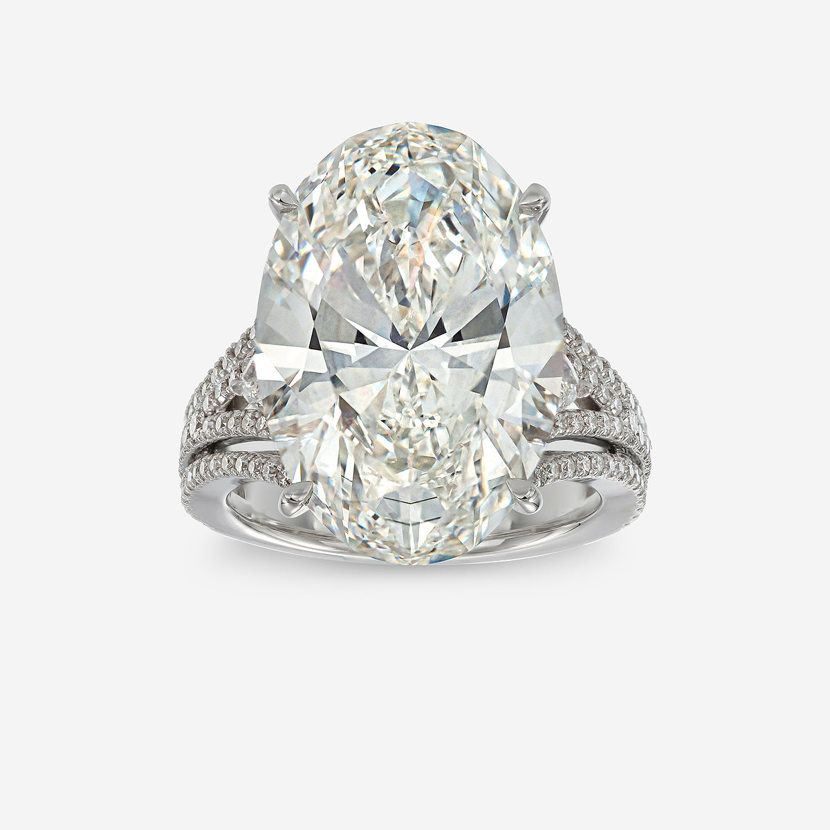 Diamond ring with a pear-shaped center stone on a white background