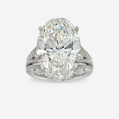 Diamond ring with a pear-shaped center stone on a white background