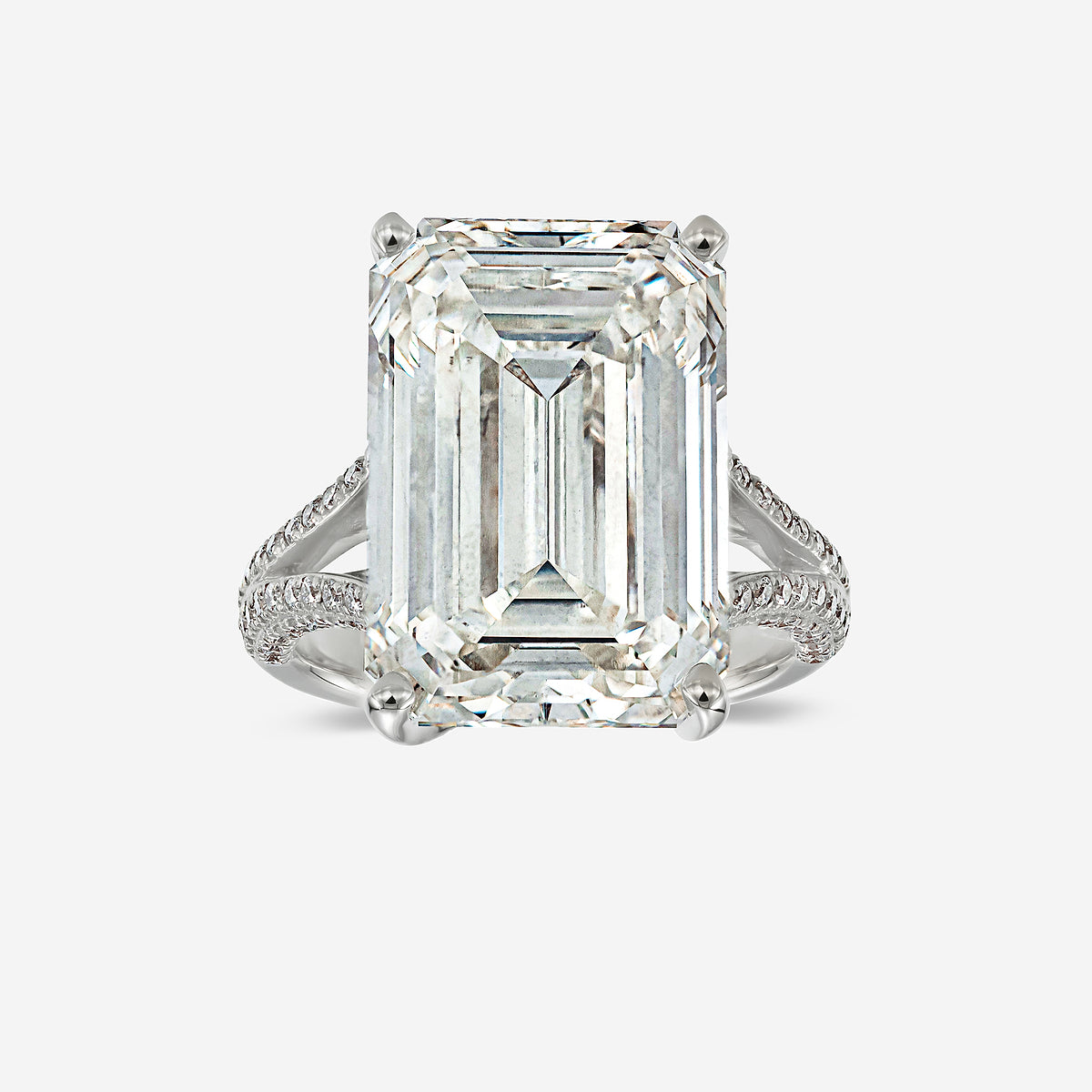 Diamond ring with emerald-cut diamond on a white background