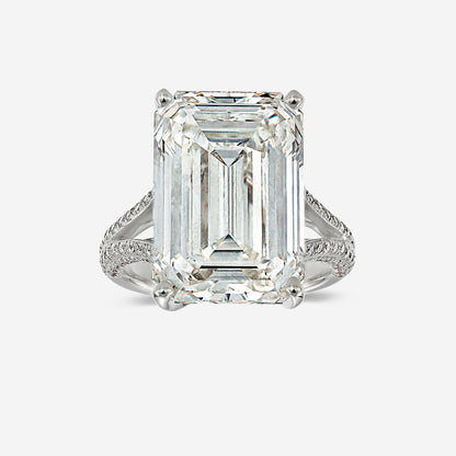 Diamond ring with emerald-cut diamond on a white background