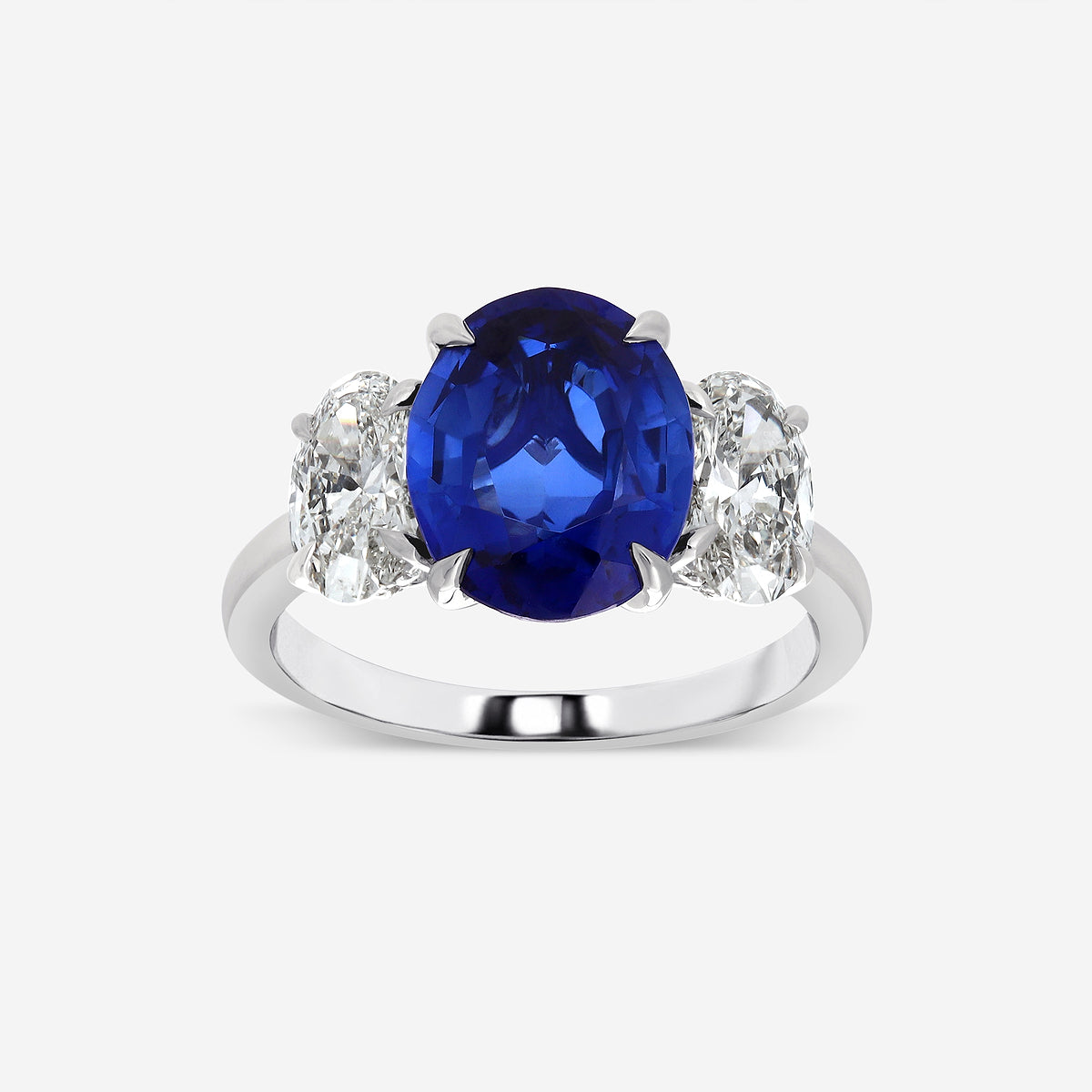 Ring with a blue gemstone and diamond accents on a white background