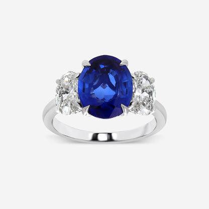 Ring with a blue gemstone and diamond accents on a white background