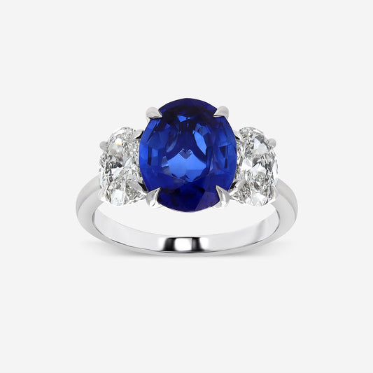 Ring with a blue gemstone and diamond accents on a white background