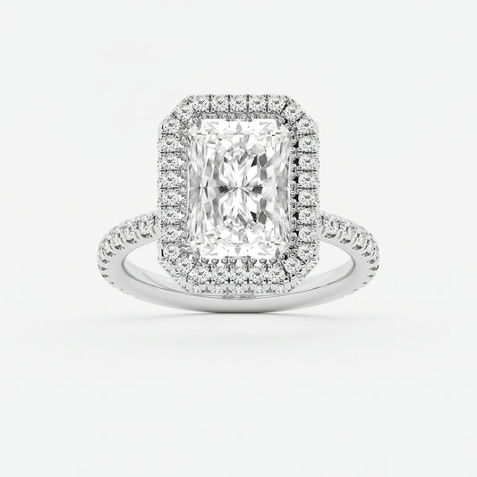 Diamond ring with a rectangular center stone and halo on a light gray background