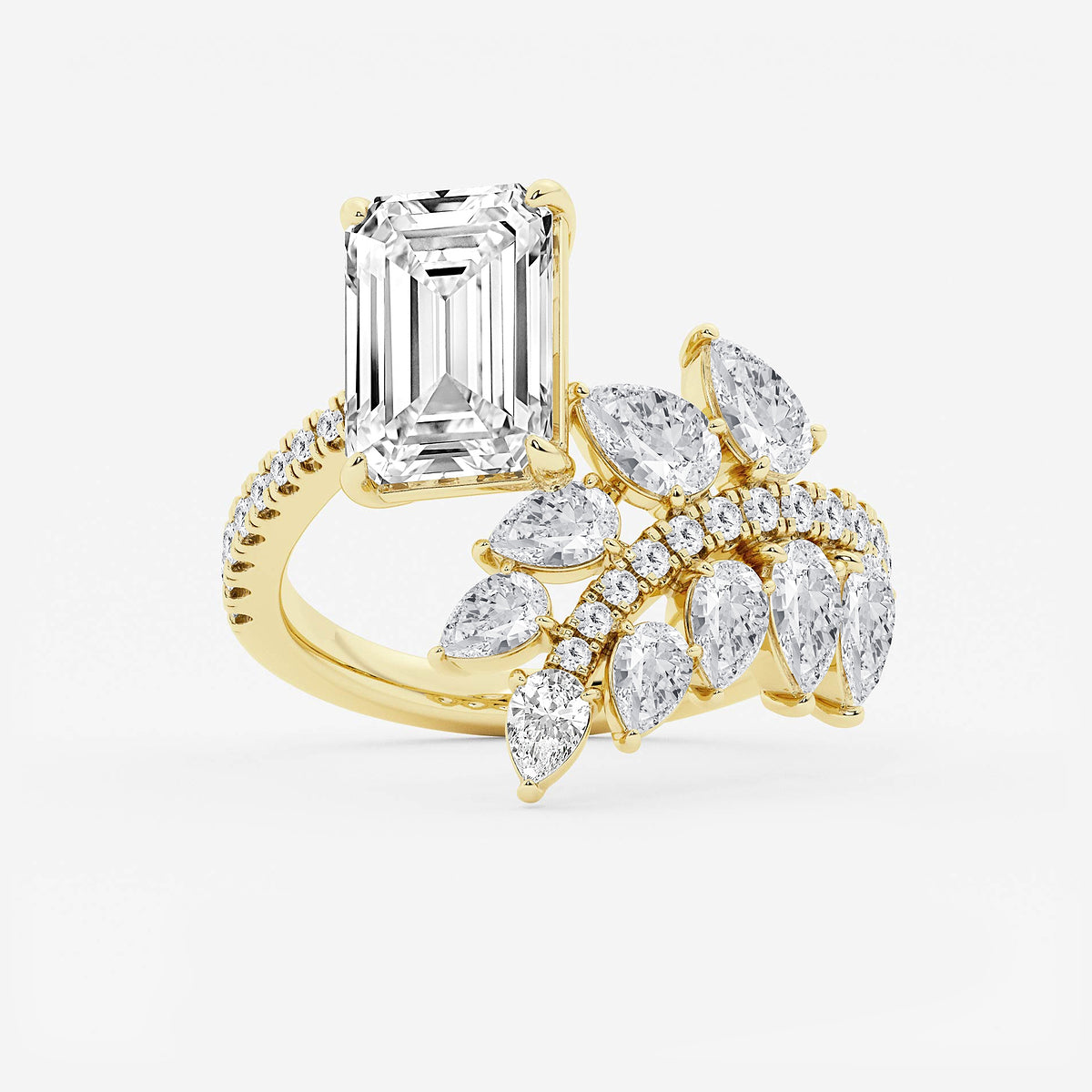 Gold ring with emerald-cut diamond and marquise-shaped gemstones on a white background