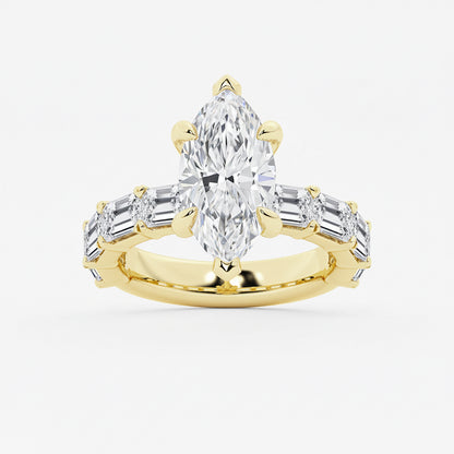Gold ring with a pear-shaped diamond and baguette-cut diamonds on a white background