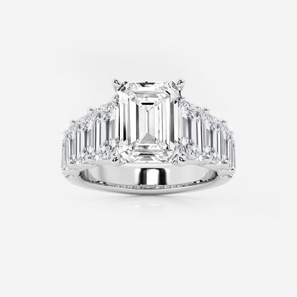Diamond ring with emerald-cut center stone and baguette side stones on a white background