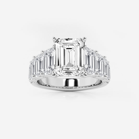 Diamond ring with emerald-cut center stone and baguette side stones on a white background