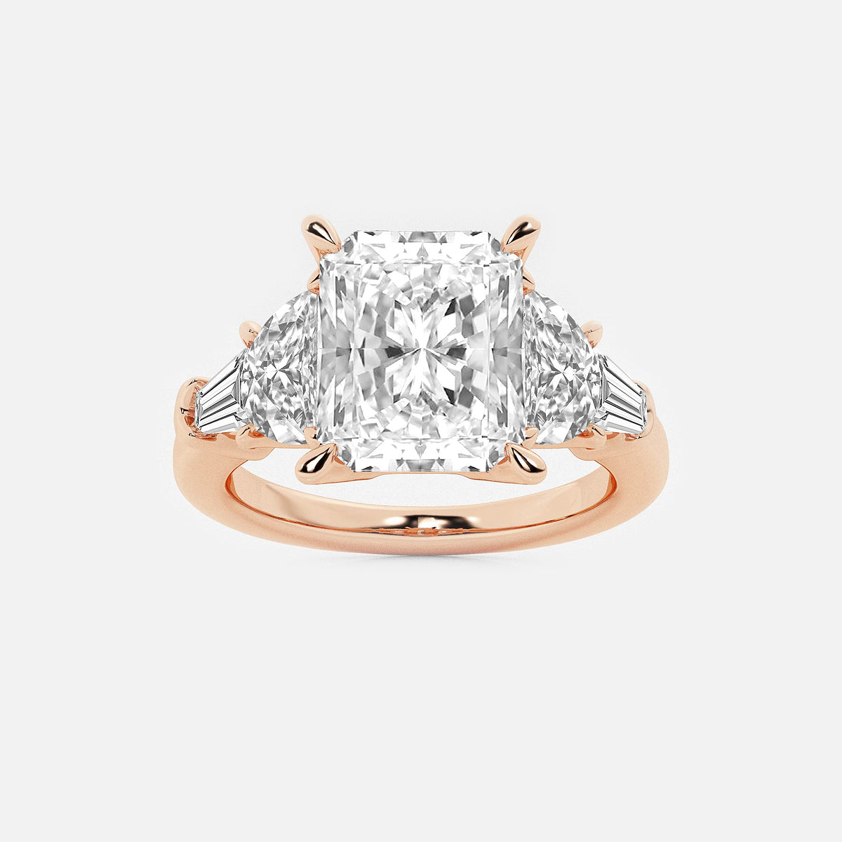 Rose gold ring with a large diamond and smaller triangular diamonds on a white background