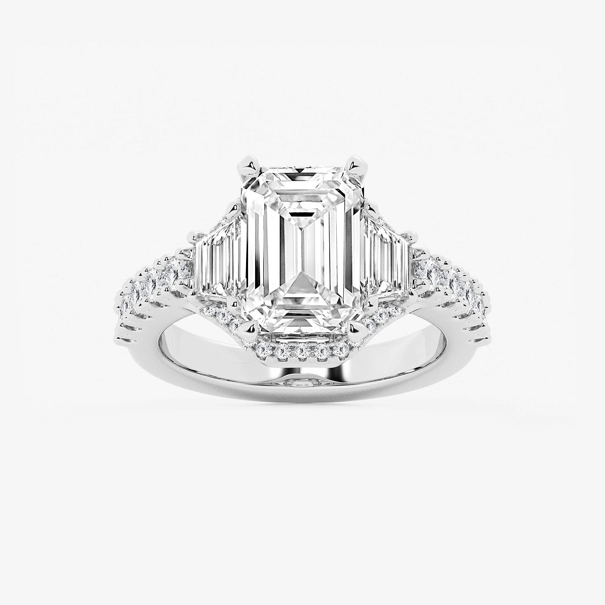 Diamond ring with emerald-cut center stone and smaller diamonds on a white background