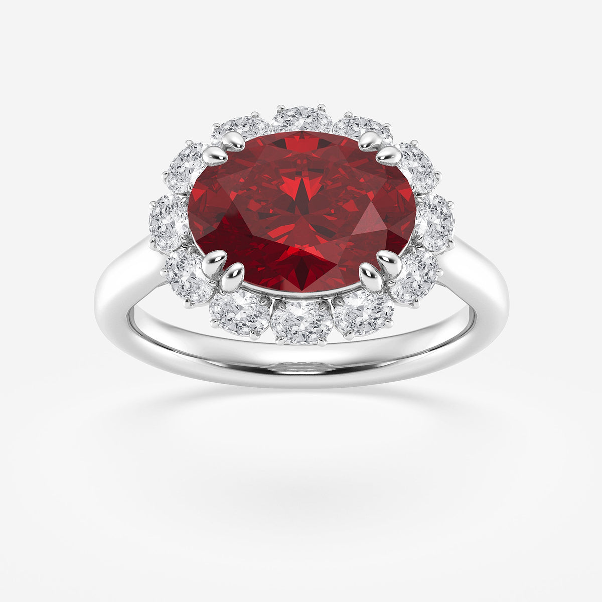 Ring with a red gemstone and diamond halo