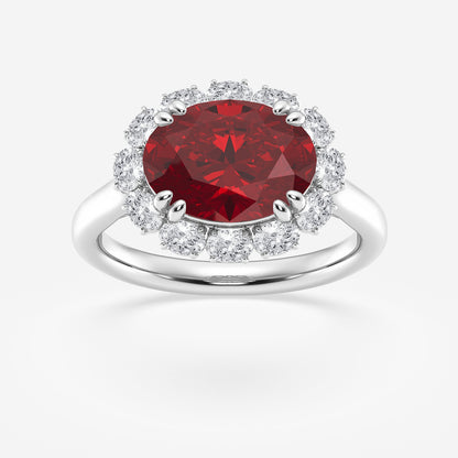 Ring with a red gemstone and diamond halo