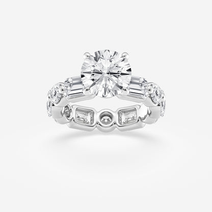 Diamond ring with a central round diamond and side baguette diamonds on a light gray background