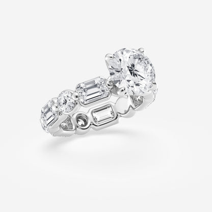 Diamond ring with multiple gemstones on a light gray background