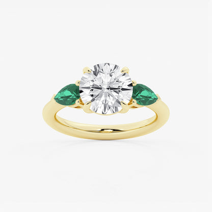 Gold ring with a diamond and emeralds on a white background