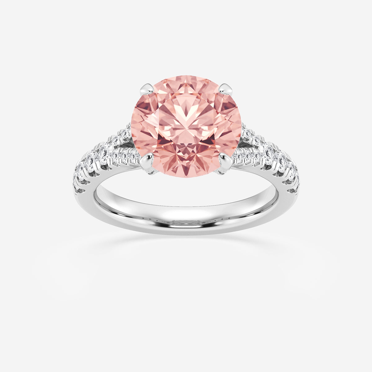 Ring with a pink gemstone and diamond-studded band on a white background