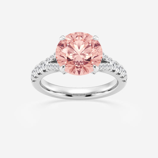 Ring with a pink gemstone and diamond-studded band on a white background