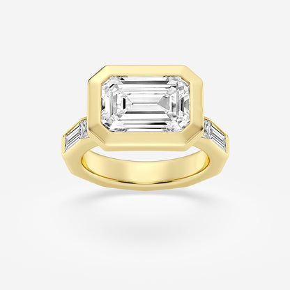 Gold ring with a large emerald-cut diamond and smaller side stones on a white background