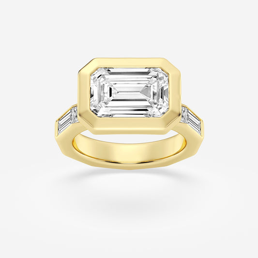 Gold ring with a large emerald-cut diamond and smaller side stones on a white background