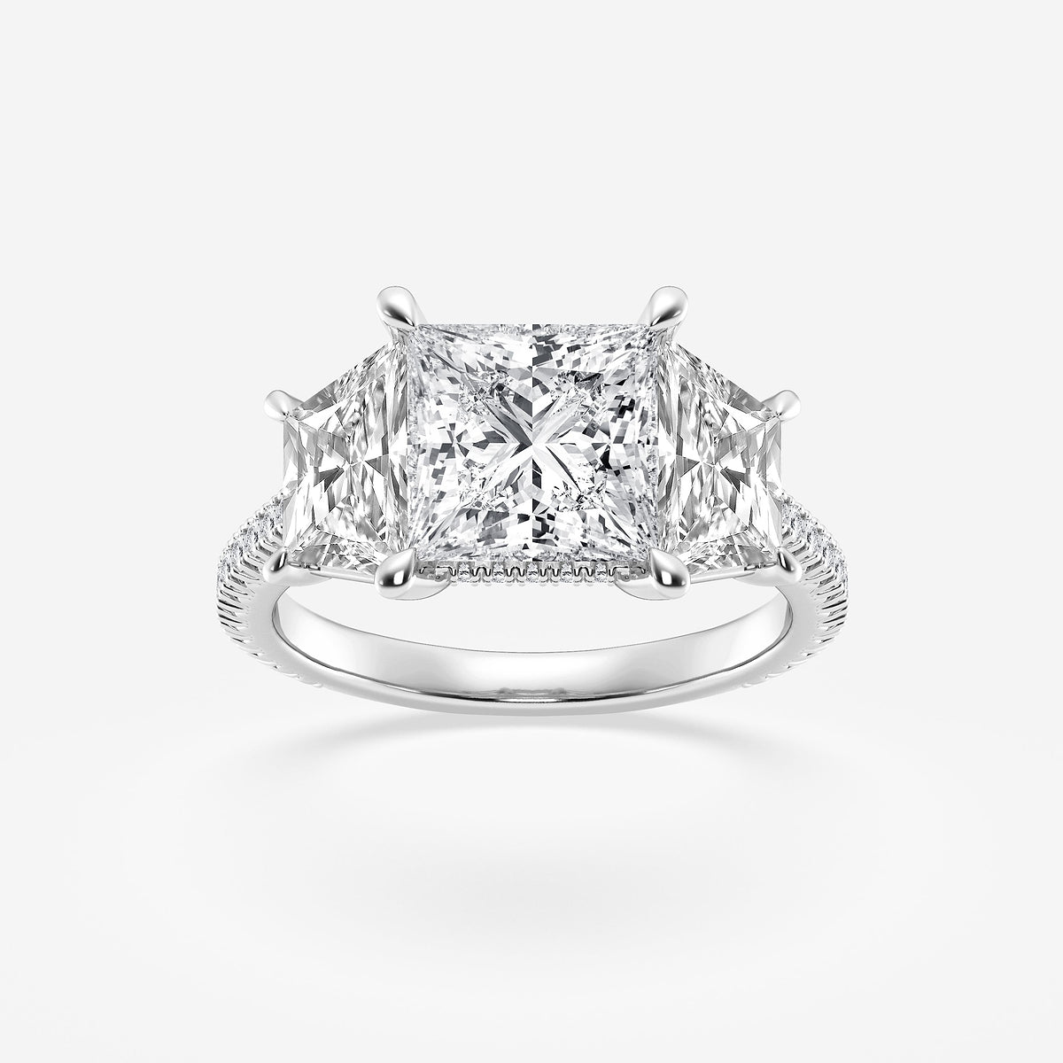 Diamond ring with a princess-cut center stone on a white background