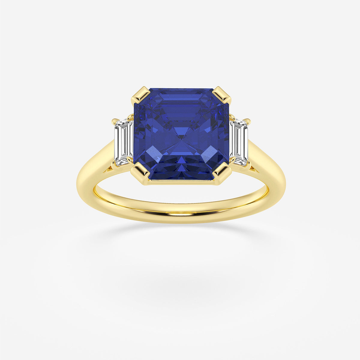Gold ring with a blue gemstone and two smaller diamonds on a white background