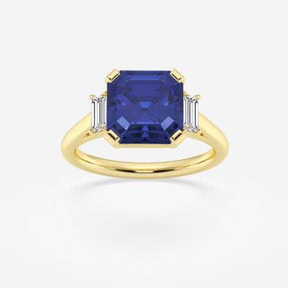 Gold ring with a blue gemstone and two smaller diamonds on a white background