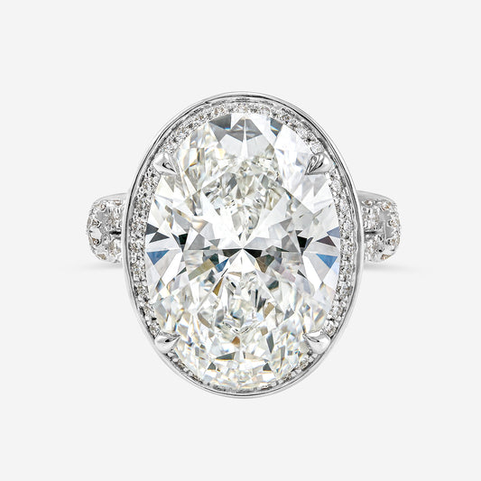 Diamond ring with a large central gemstone and smaller stones on a white background