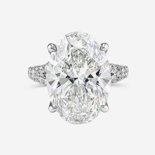 Diamond ring with two large pear-shaped diamonds on a white background